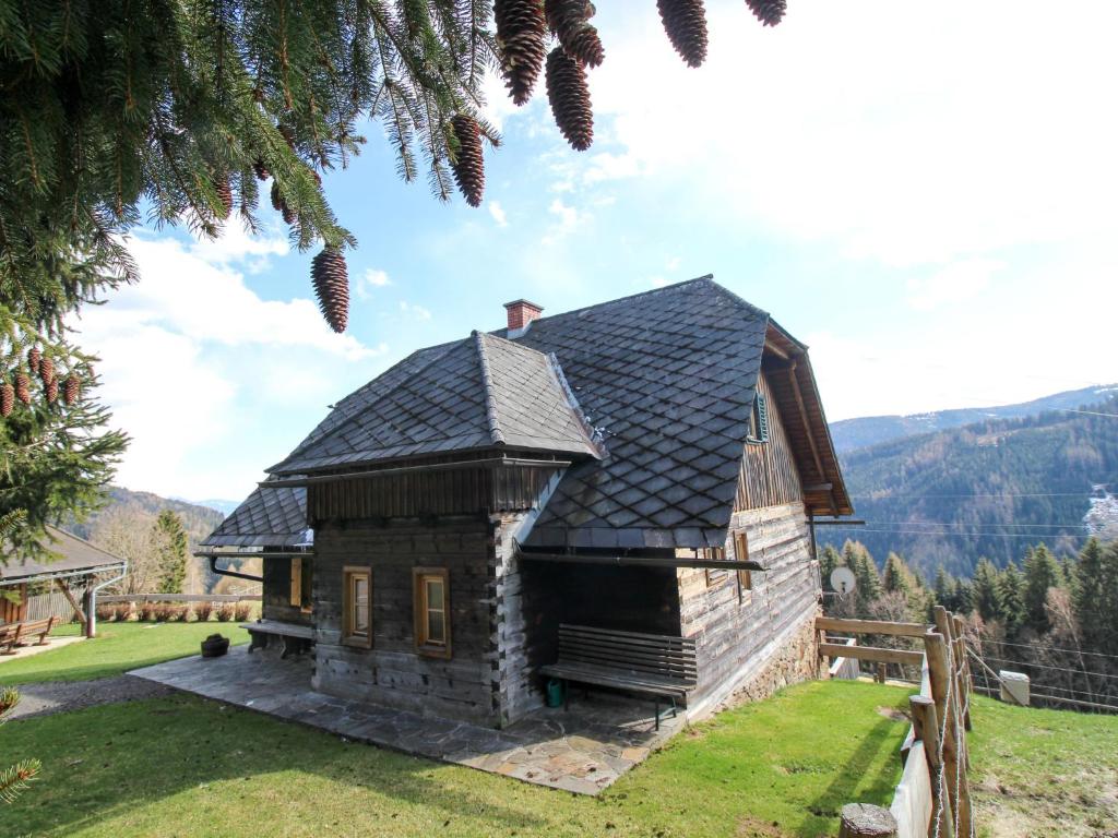a small house with a black roof on a field at Chalet Kopphütte by Interhome in Preims