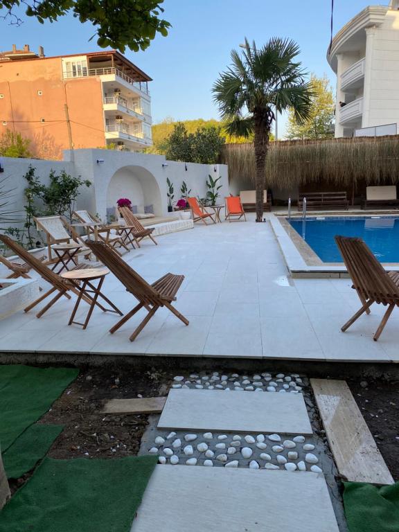 a patio with lounge chairs and a swimming pool at EVİM APART HOTEL in Termal