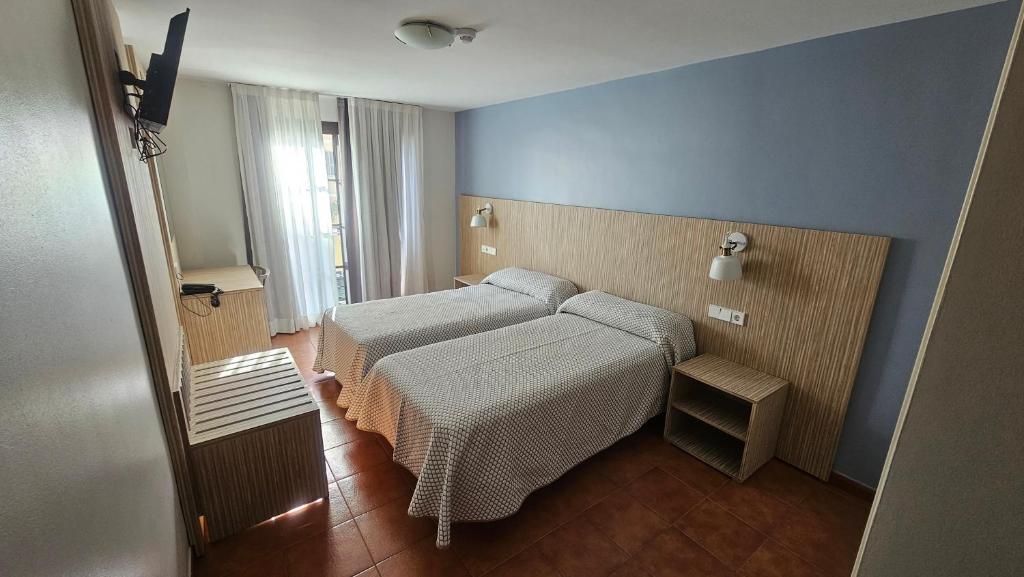 Posteľ alebo postele v izbe v ubytovaní Hotel Galicia