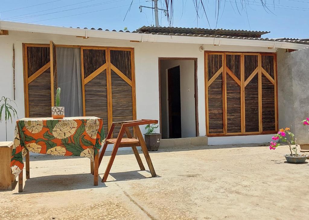 a chair sitting in front of a house at Hostel Nugeku in Rincón