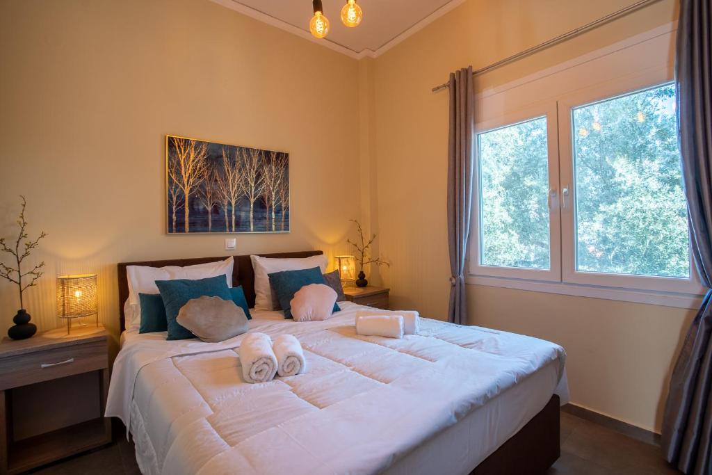 a bedroom with a large bed with two stuffed animals on it at Two Bedroom Apartment, Mytilene Lesvos in Mytilini