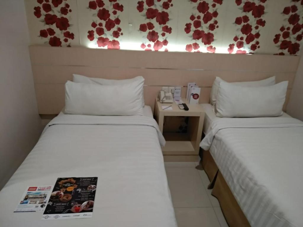 Postel nebo postele na pokoji v ubytování Cordela Hotel Medan