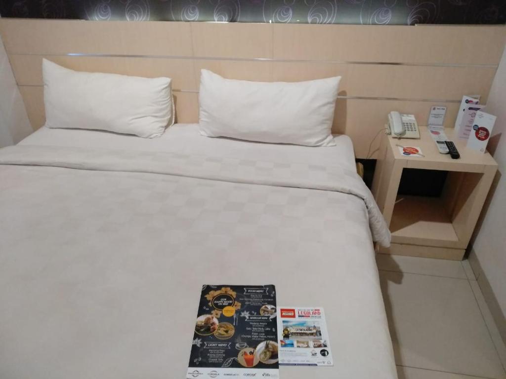 Postel nebo postele na pokoji v ubytování Cordela Hotel Medan