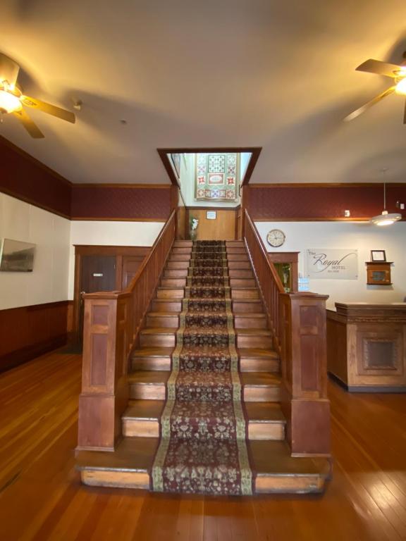 an empty room with a staircase with a rug at Royal Hotel Chilliwack in Chilliwack