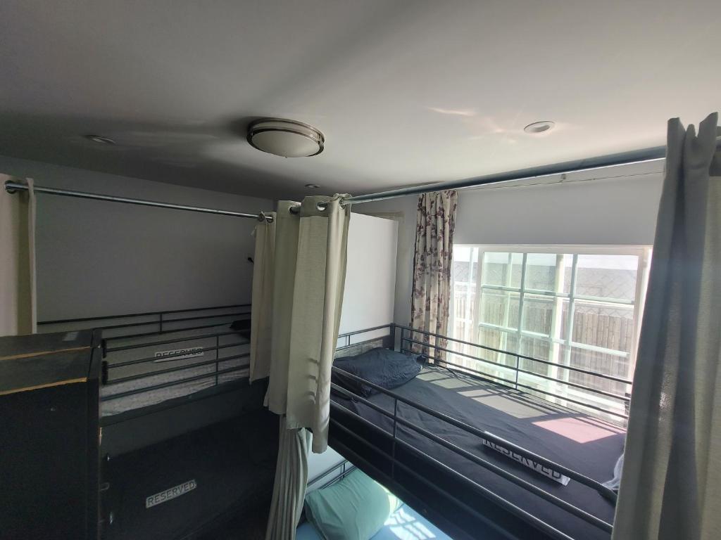 a room with two bunk beds and a window at Roomi in Los Angeles