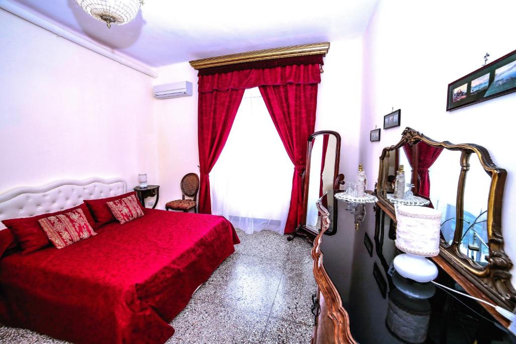 a bedroom with a red bed and a window at WELL COME - Santa Lucia in Naples