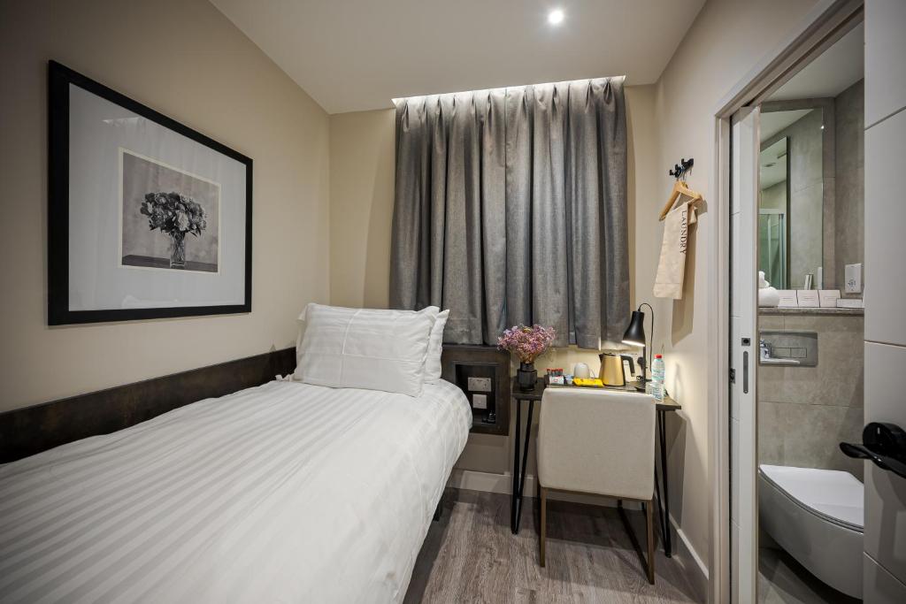 Postel nebo postele na pokoji v ubytování King's Cross Express Inn