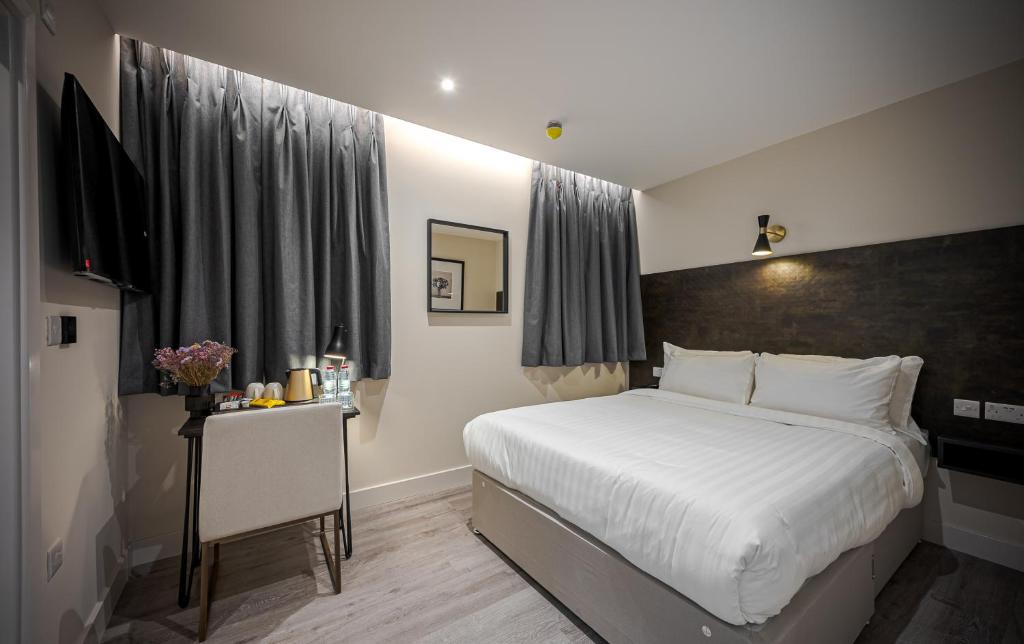 Postel nebo postele na pokoji v ubytování King's Cross Express Inn