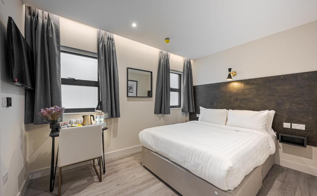Postel nebo postele na pokoji v ubytování King's Cross Express Inn