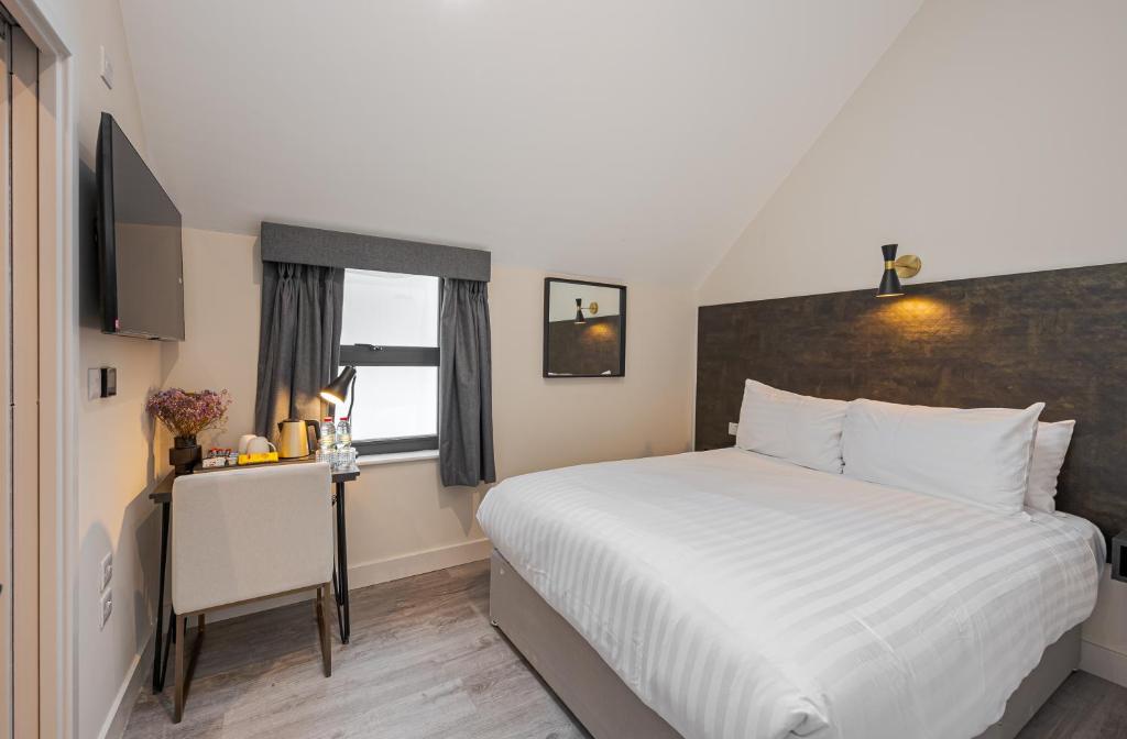 Postel nebo postele na pokoji v ubytování King's Cross Express Inn