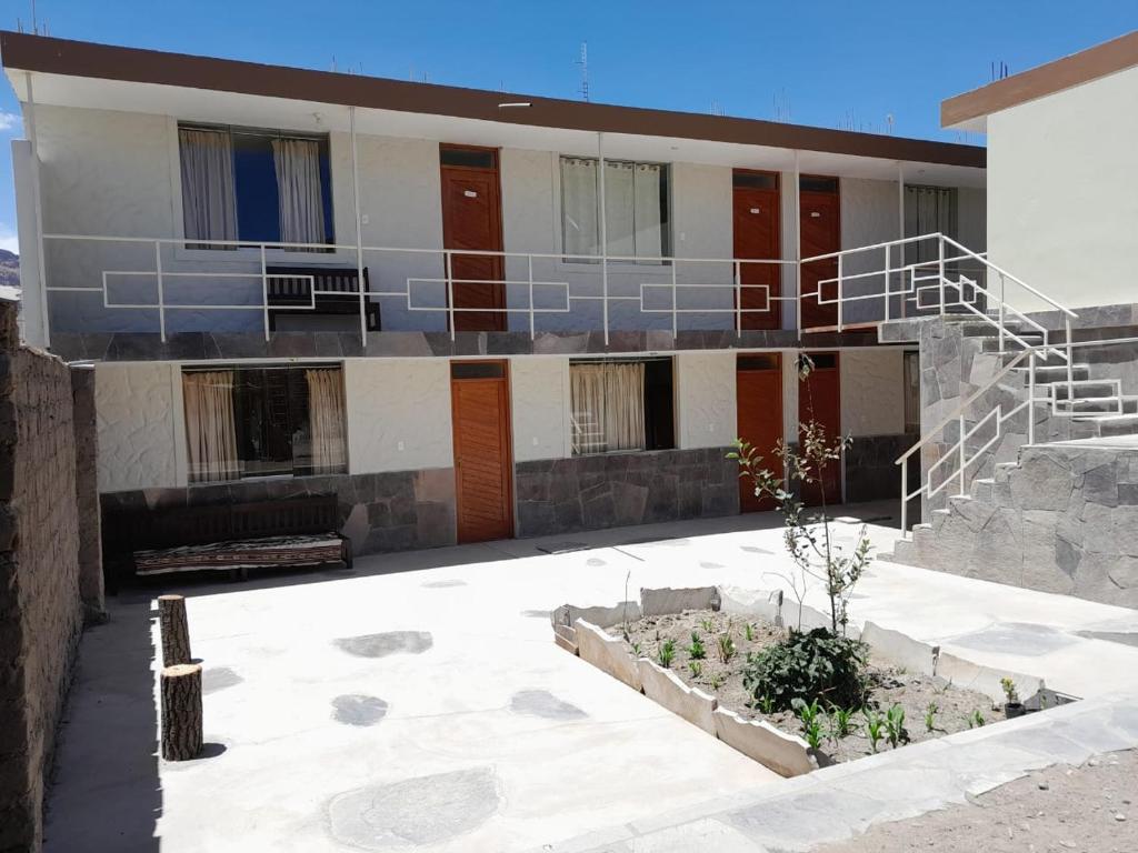 a building with a staircase in front of it at Antawara in Chivay