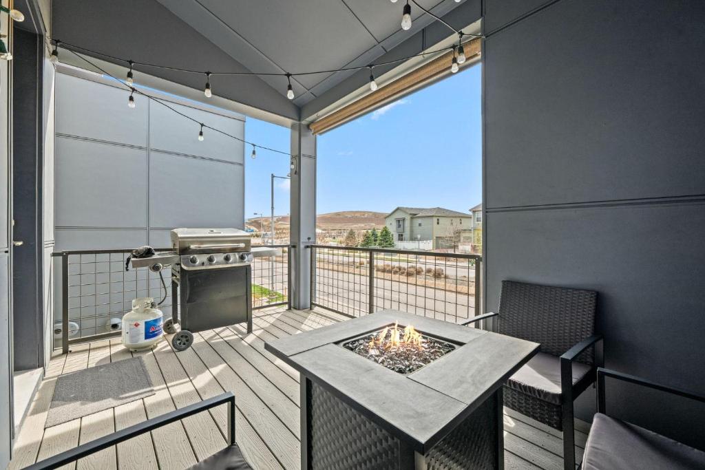 a patio with a table and a grill on a deck at Uptown Avenue - Broomfield in Broomfield