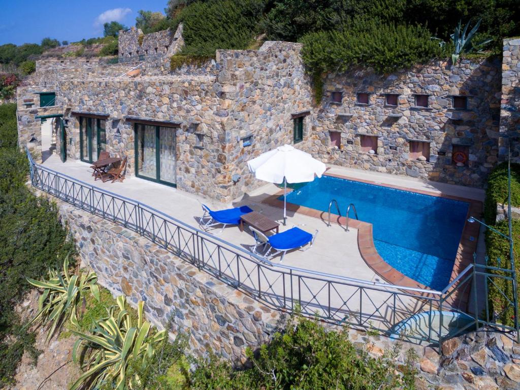 an external view of a stone house with a swimming pool at Seaview villa Amphitriti with Private Pool, 20 min from Elafonissi beach in Chania