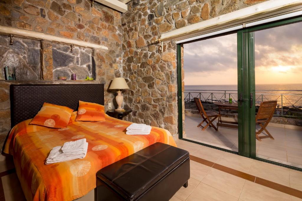 a bedroom with a bed and a view of the ocean at Seaview villa Amphitriti with Private Pool, 20 min from Elafonissi beach in Chania Town
