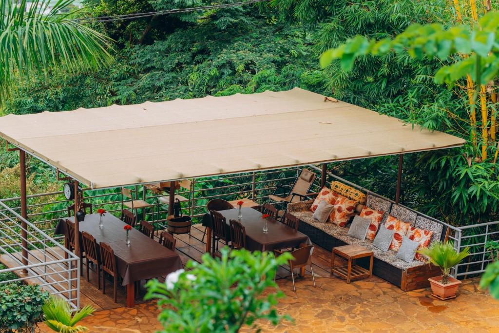 a restaurant with tables and chairs under a tent at Edelwyss-Inn in Morogoro