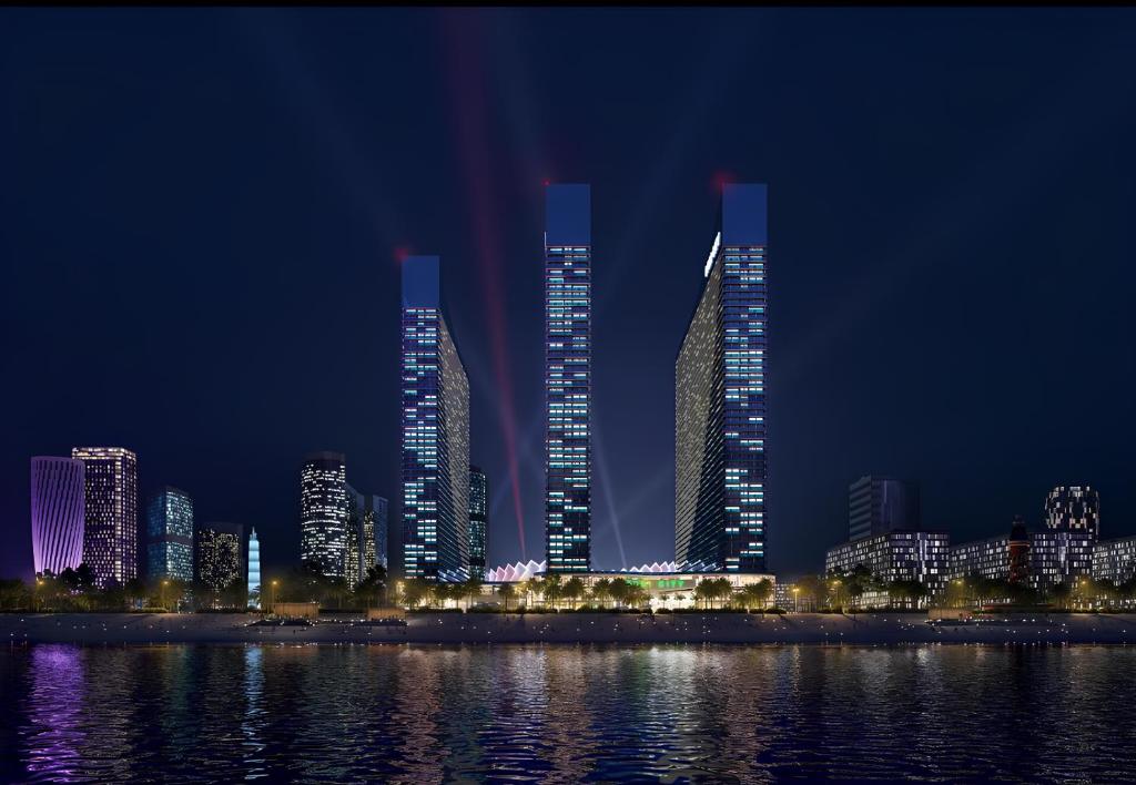 grupa wysokich budynków w mieście w nocy w obiekcie Orbi City Sea View Aparthotel w mieście Batumi