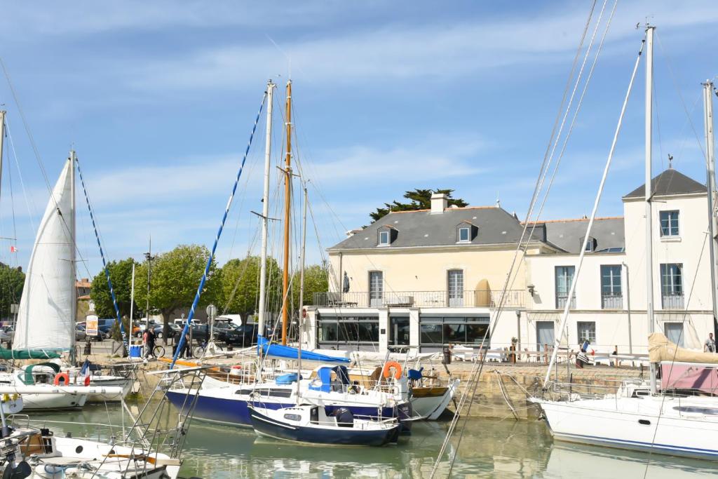 a group of boats are docked in a harbor at Le Général d'Elbée Hotel & Spa - Teritoria in Noirmoutier-en-l'lle