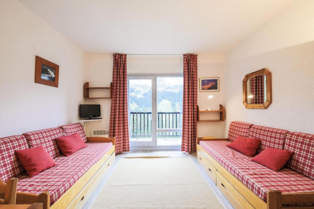 un salon avec deux canapés et un balcon dans l'établissement Résidence Andromède - maeva Home - Studio 4 Personnes - Confort MAE-3651, à Flaine