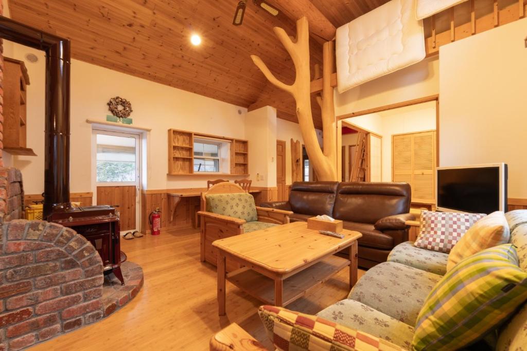 a living room with a couch and a table at Yubari Shikanotani residence - Vacation STAY 16529 in Yubari