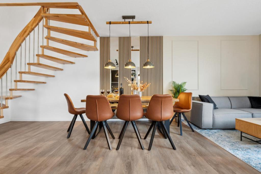 uma sala de jantar e sala de estar com mesa e cadeiras em NEU! Design-FeWo Heidetraum em Bad Fallingbostel
