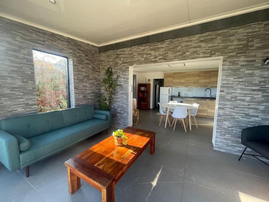 a living room with a blue couch and a table at Dépendance au sein d’une villa avec piscine in Aix-en-Provence