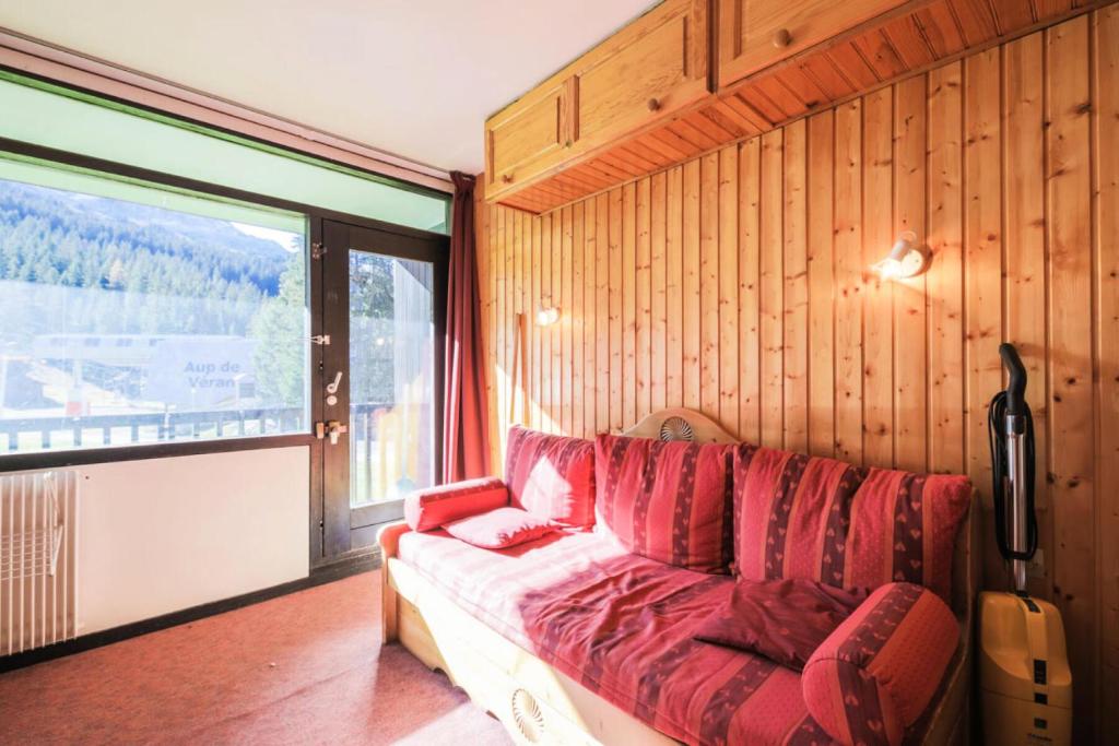 a living room with a couch and a large window at Résidence Antarès - maeva Home - Studio 4 Personnes - Budget 62 in Flaine