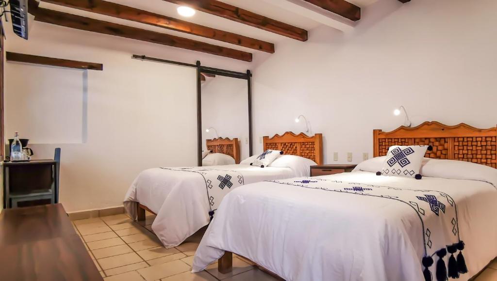 Postel nebo postele na pokoji v ubytování Hotel Ocho Barrios