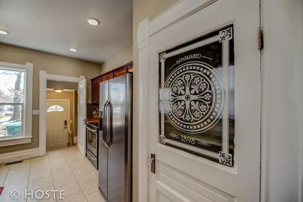 a kitchen with a door with a poster on the wall at 3BR Charming Modern Victorian Home Downtown in Colorado Springs