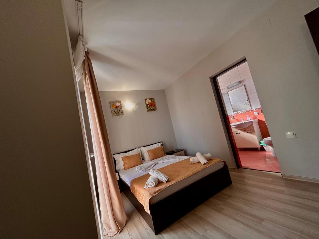 1 dormitorio con cama y espejo grande en Pensiunea Regalux, en Eforie Nord