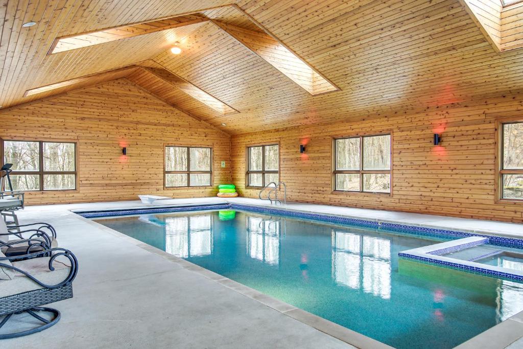 a large indoor swimming pool with a wooden ceiling at Family Home with Indoor Pool about 2 Mi to Elkhart Lake! in Elkhart Lake
