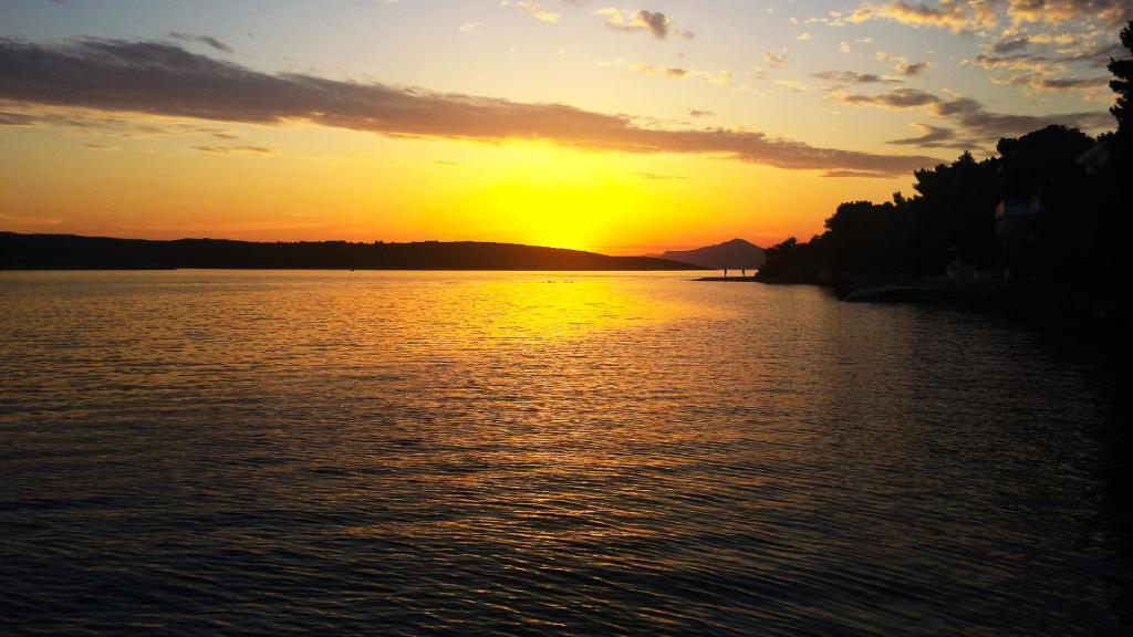 a sunset over a large body of water at Holiday House Doda in Povlja