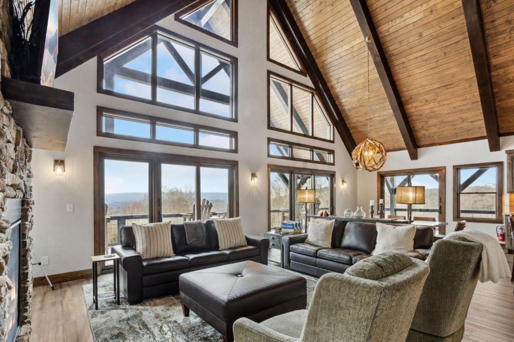 a living room filled with furniture and windows at Mountain View Manor in Banner Elk