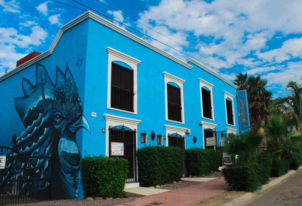 a blue building with a painting on it at Gallo Azul, Downtown Loft Style Apartment in Todos Santos