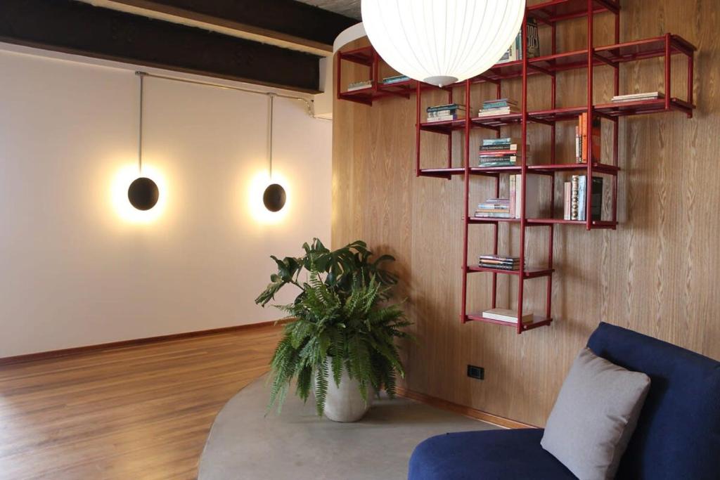 a living room with a blue couch and a plant at Amazing Vintage Apartment in Centro Internacional RColon 601 in Bogotá