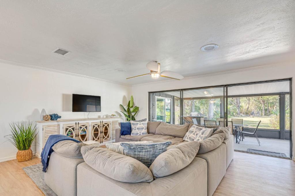 a living room with a couch and a tv at Charming Riverfront Home with Kayaks! in Crystal River