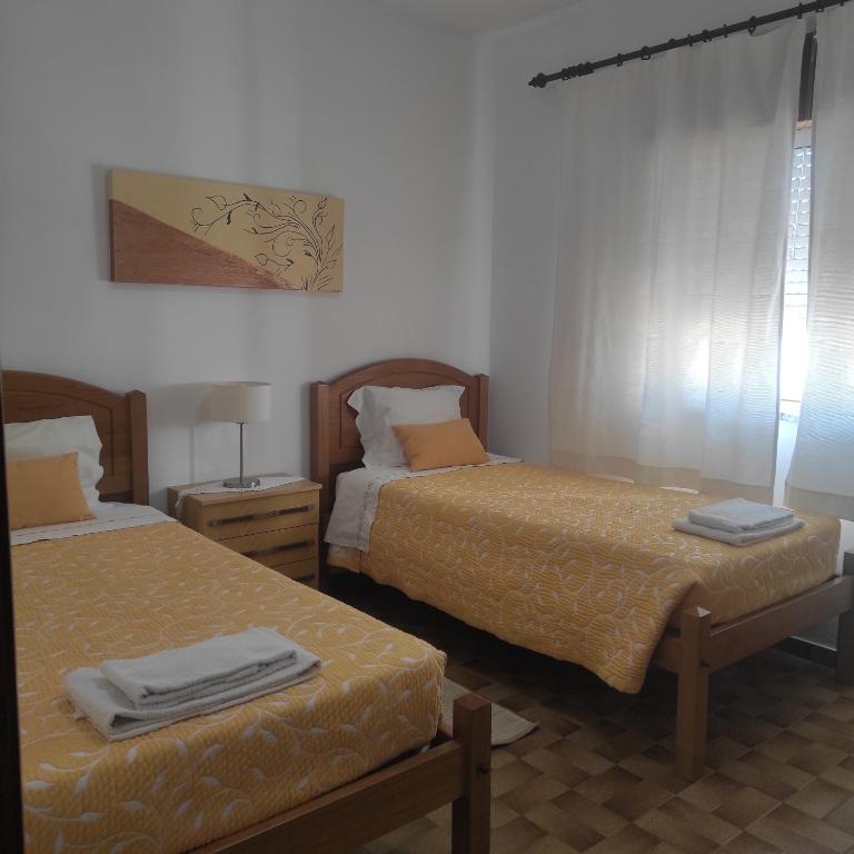 two beds in a room with two beds sidx sidx sidx at Casa Furtado in Burgau