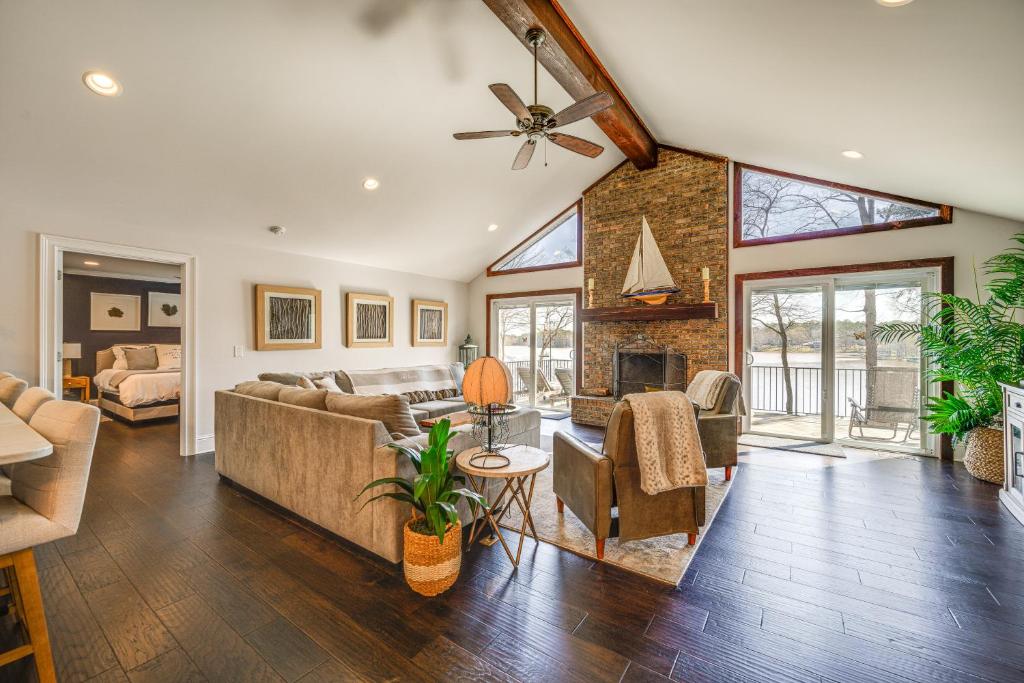 a living room with a couch and a fireplace at Lakefront Lake Oconee Home Boat Dock and Hot Tub in Eatonton 