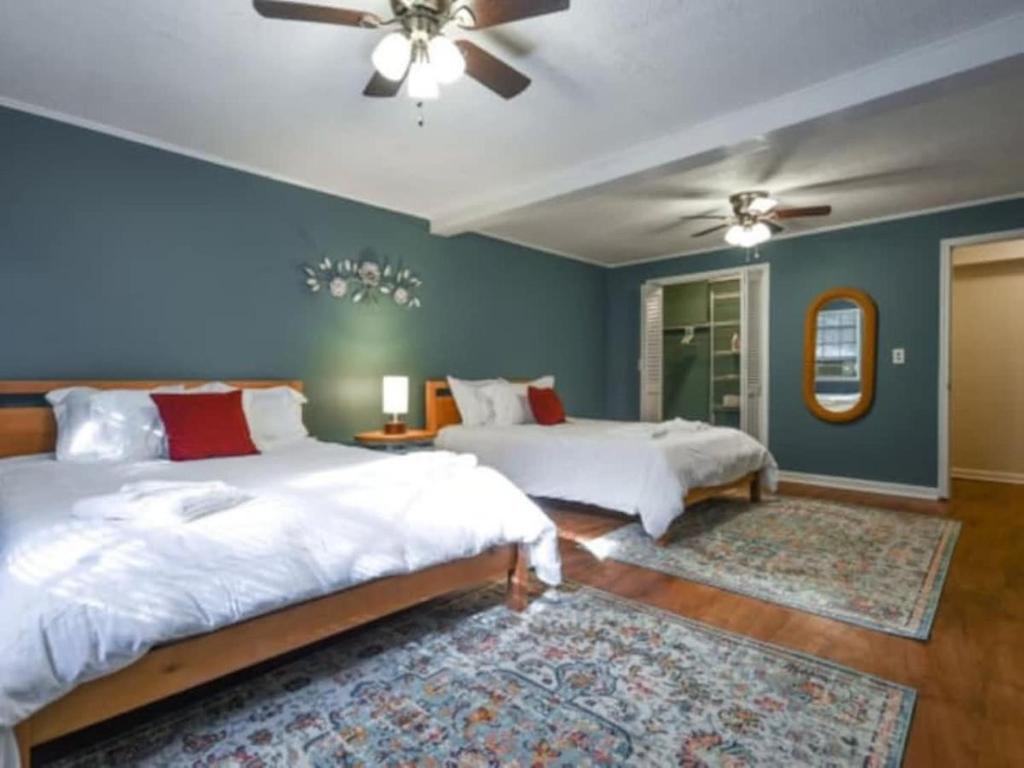 a bedroom with two beds and a ceiling fan at The Glory Glory Cottage Guest Suite Huge Yard in Athens