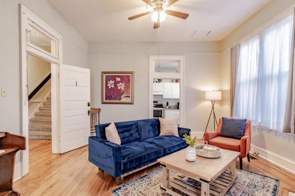 a living room with a blue couch and a table at Dauphin District Darling #1-Downtown, Restaurants in Mobile