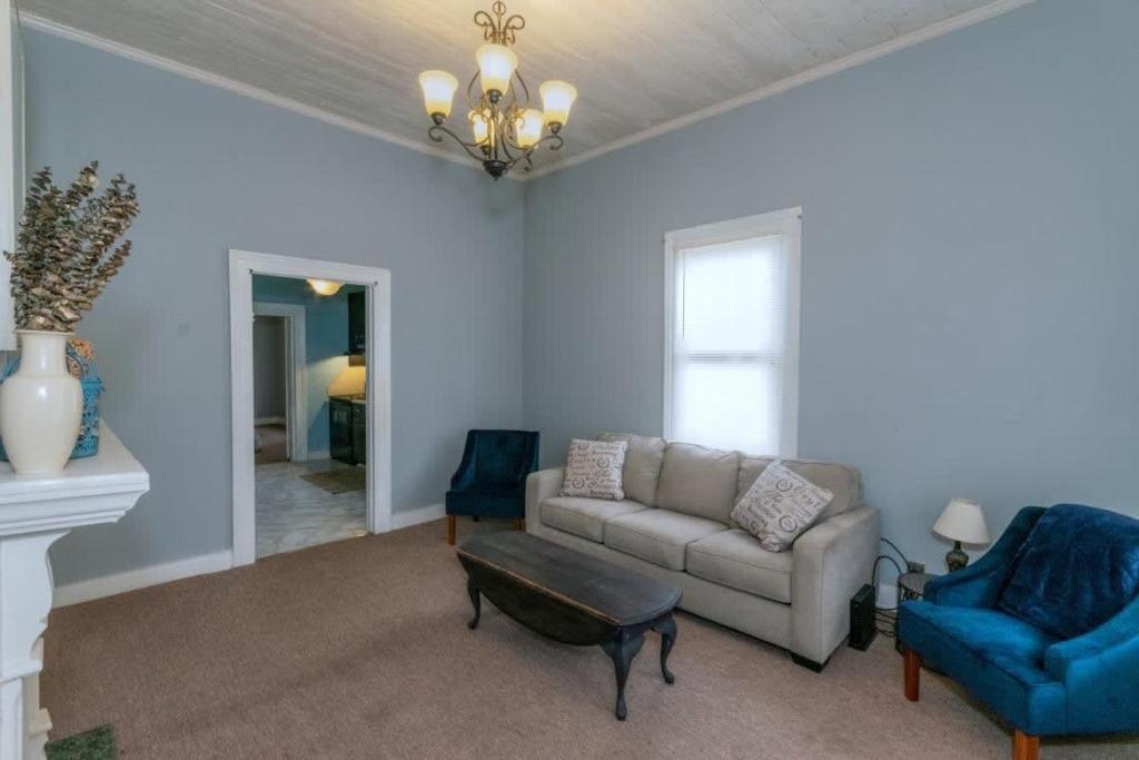 a living room with a couch and a chair at Banks of the Chattahoochee Cottage Walk to Dining in Columbus