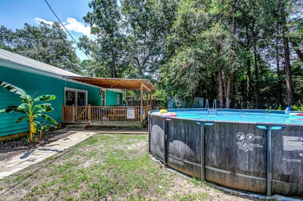 a house with a swimming pool in the yard at Sweet Sunny Retreat- Main House in Savannah