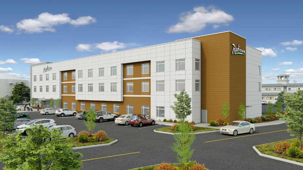 a rendering of a building with cars parked in a parking lot at Radisson Hotel Pendleton Airport in Pendleton