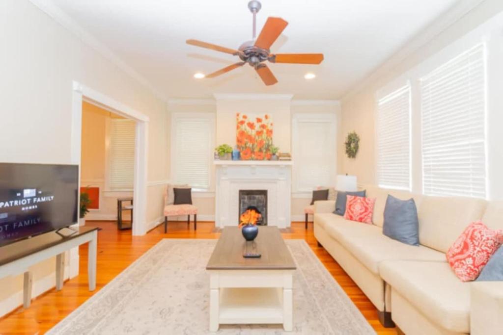 a living room with a couch and a fireplace at The Parkside Cottage Lakebottom Park at Doorstep! in Columbus