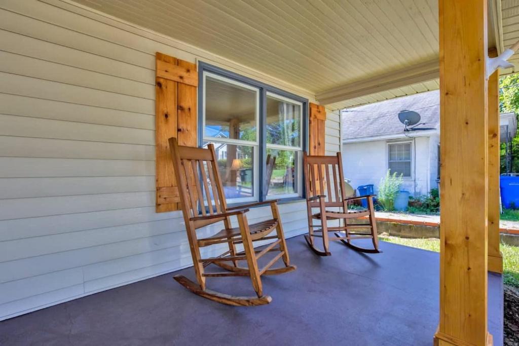 two rocking chairs sitting on the front porch of a house at The Precious Pearl- Close to downtown, Ft Bragg, in Fayetteville