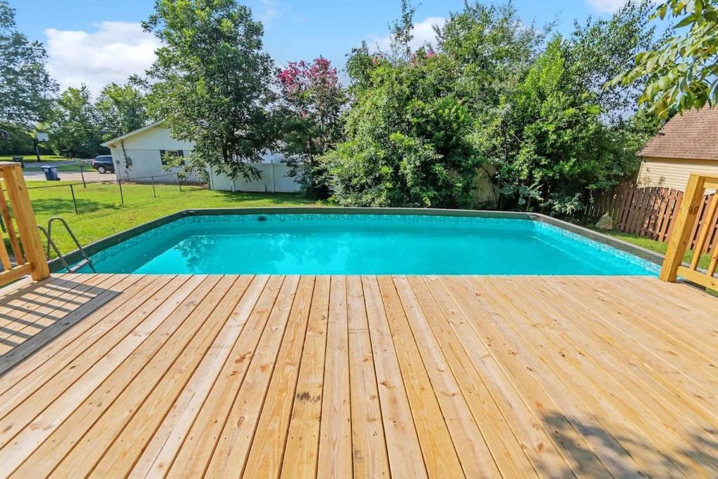 una piscina con terraza de madera junto a un patio en The Retro Pad - Large Yard and Foosball Table, en Madison