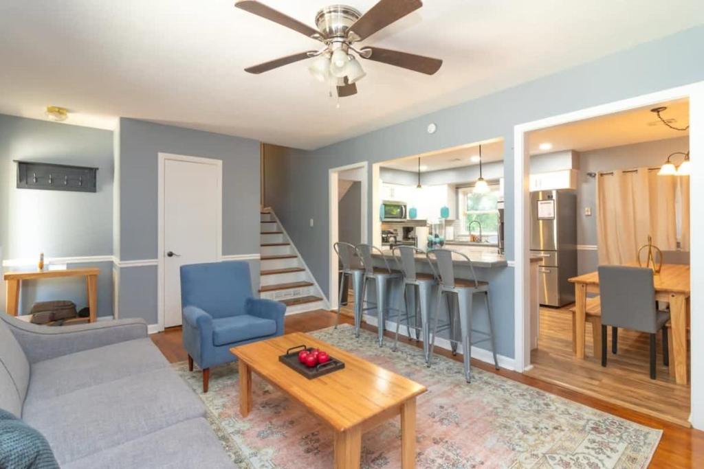 a living room with a couch and a table at Large Yard with Treehouse Tri-Level Retreat in Columbus