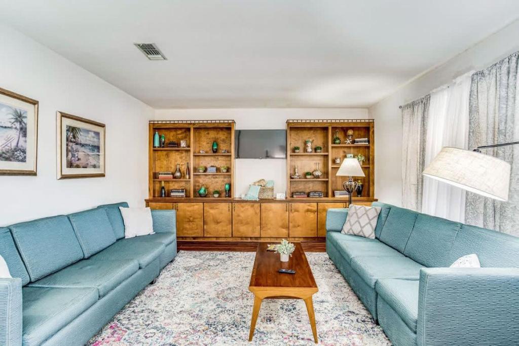 a living room with two blue couches and a coffee table at Brilliant in Bellview-Back unit-- Mins to NAS Pensacola, Beach, Shopping in Pensacola