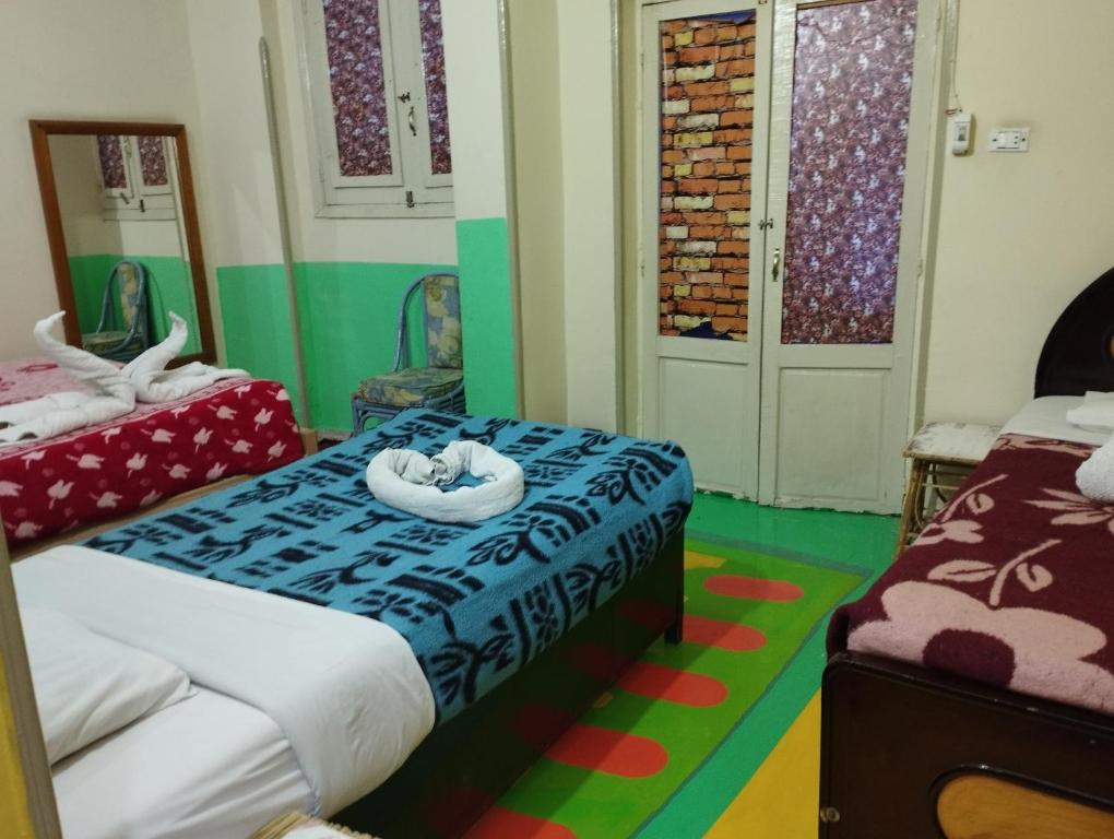a bedroom with two beds and a bedvisor with a bed at Bob Marley Peace hostels luxor in Luxor