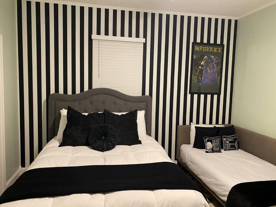 a bedroom with two beds with black and white stripes at It’s Showtime-Book Lally’s House! Steps to Common! in Salem