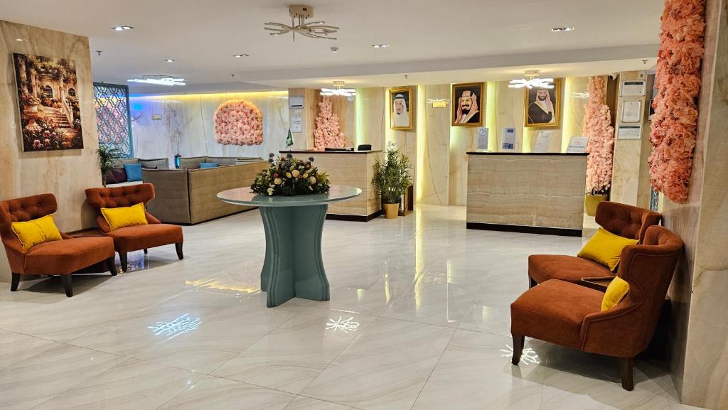 vestíbulo con zona de espera con sillas y mesa en رحال البحر للشقق المخدومة Rahhal AlBahr Serviced Apartments, en Yeda